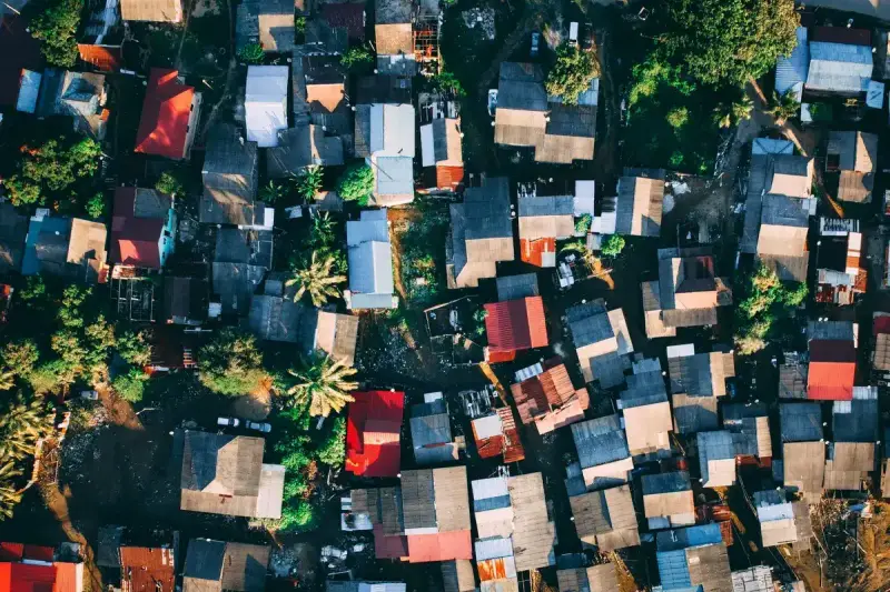Aerial view of a neighborhood showing many rooftops of different sizes and materials